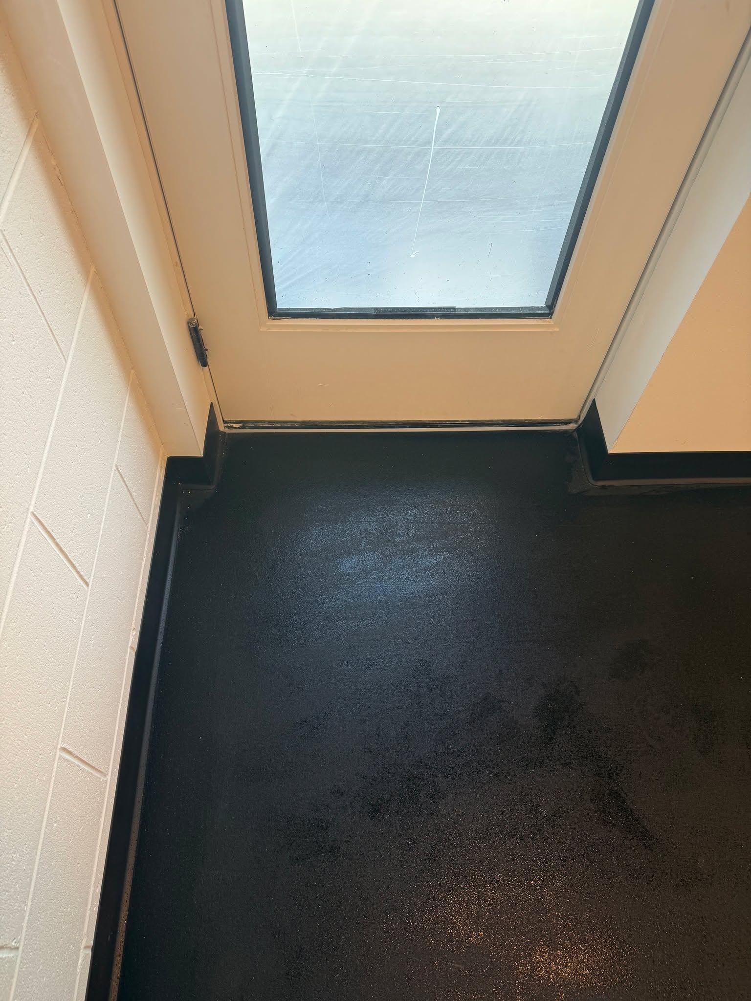 Dark LVP flooring in an entryway with a skylight overhead.