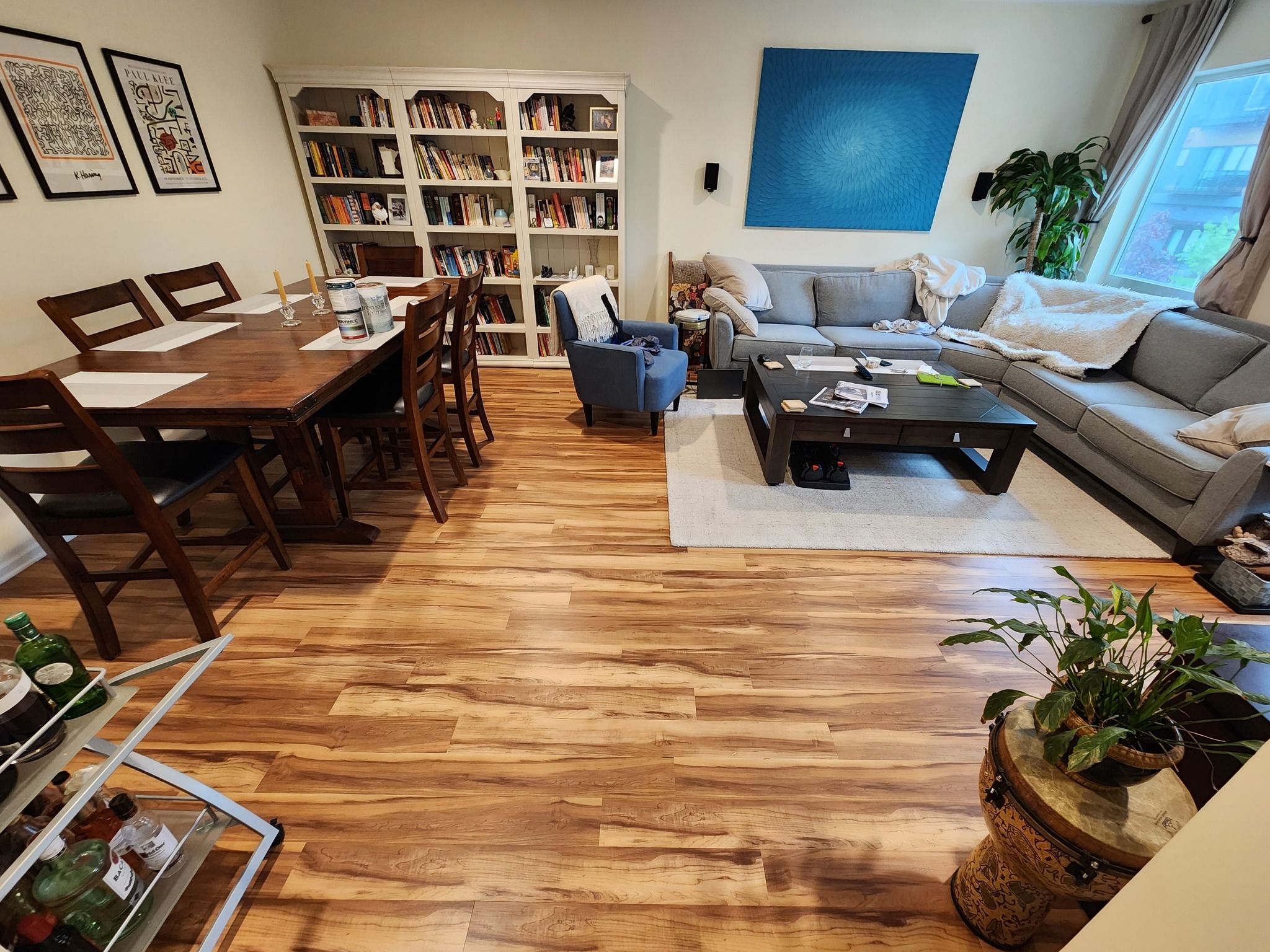 Open living and dining area with medium-toned plank LVP flooring throughout.