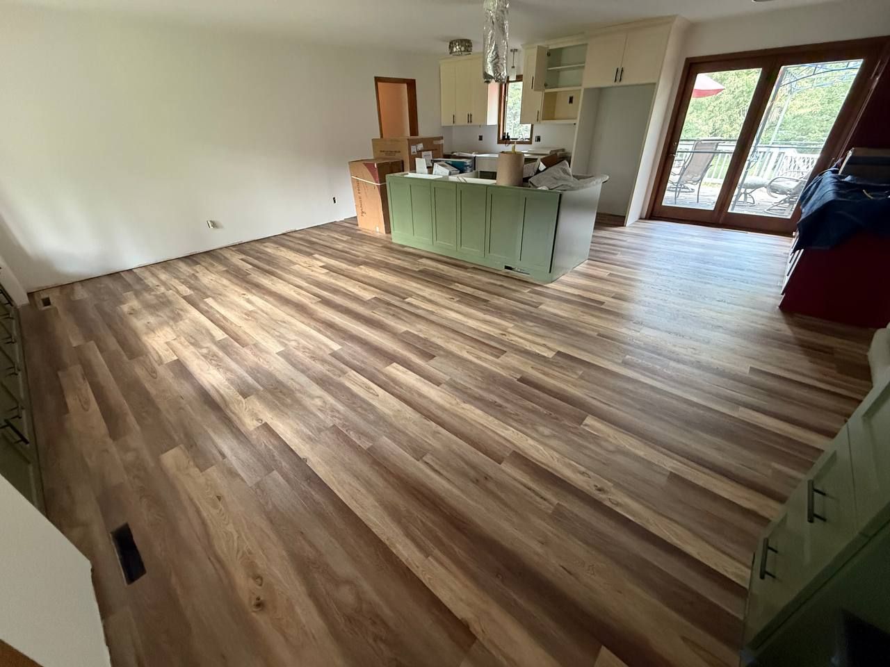Luxury vinyl plank installed through an open kitchen and living room in Dayton, MN