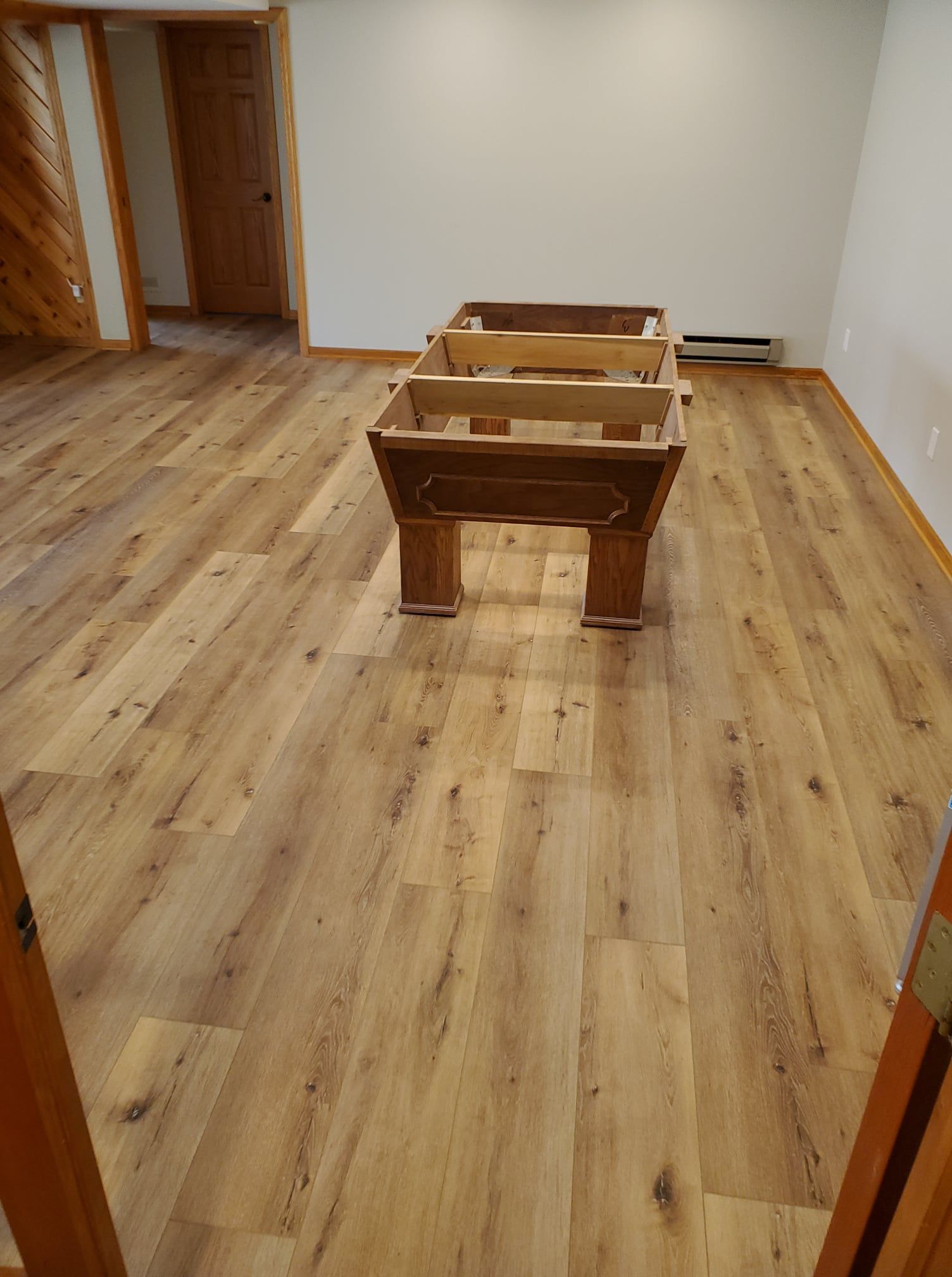 Luxury vinyl plank flooring with wood grain finish installed in a residential living space.